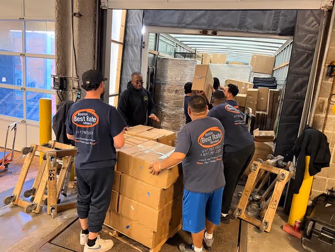 BBRM team of five loading boxes into truck at commercial dock