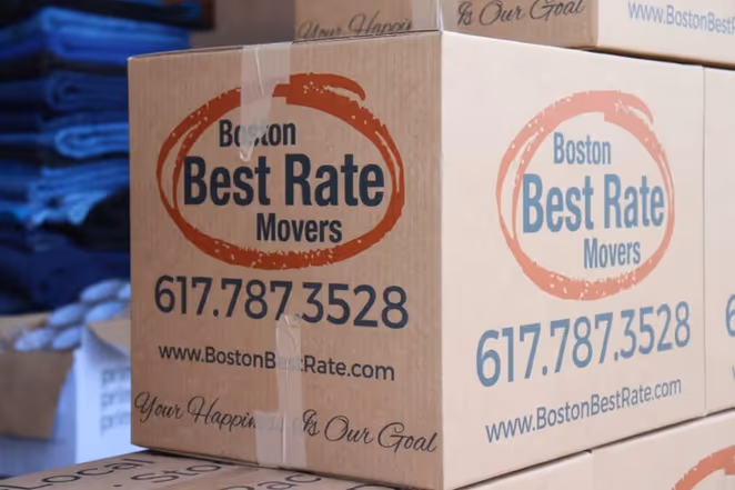 Boston movers — Boston Best Rate Movers crew loading a large wrapped item into a moving truck