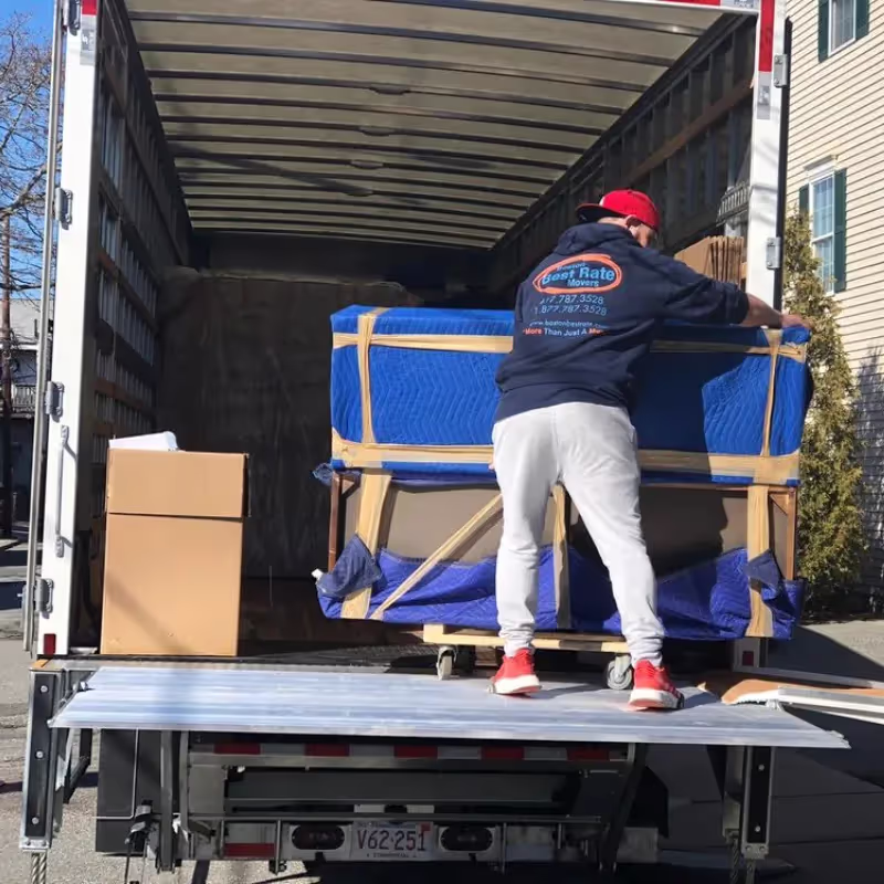 Furniture movers carrying large pieces in Boston