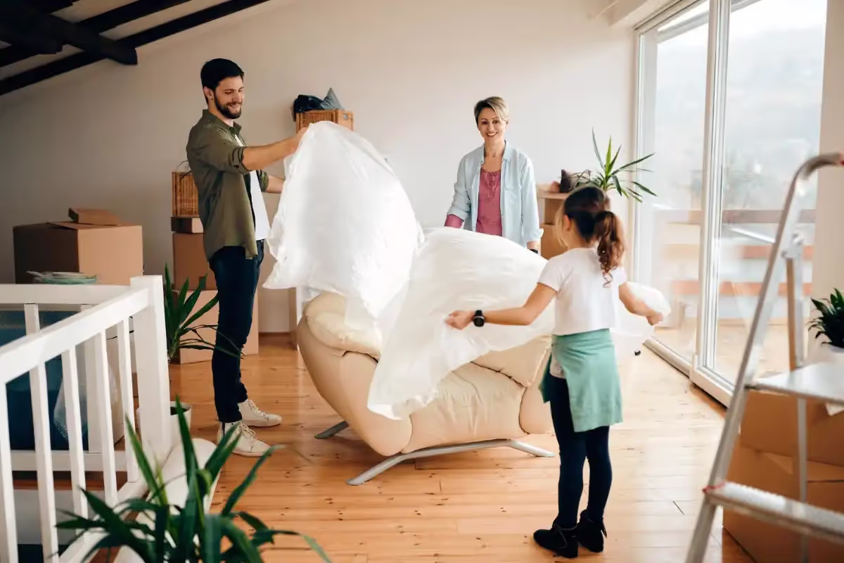 Movers carefully navigating a couch through a narrow Boston apartment stairwell