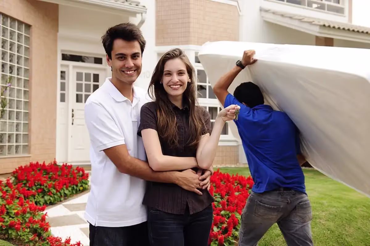 Professional Boston movers loading furniture onto moving truck with proper equipment
