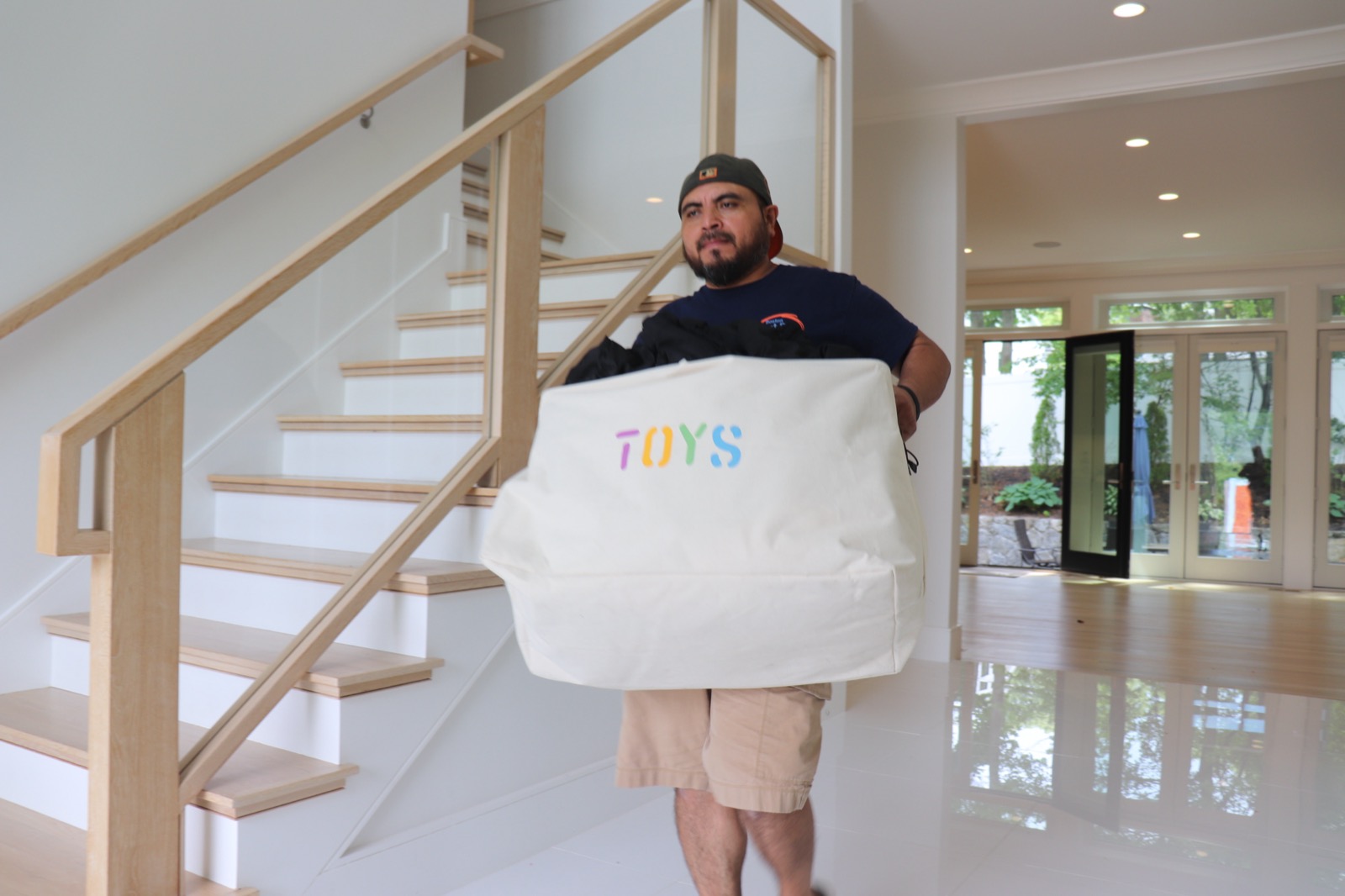 Boston Best Rate Movers crew member carefully moving items in a luxury home